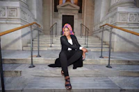 a woman sitting on the steps of a building